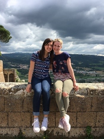 students sitting on wall italy